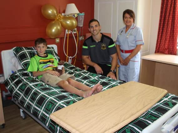 Young patients can have their room furnished with personalised bedsheets, like this boy's Saints colours.