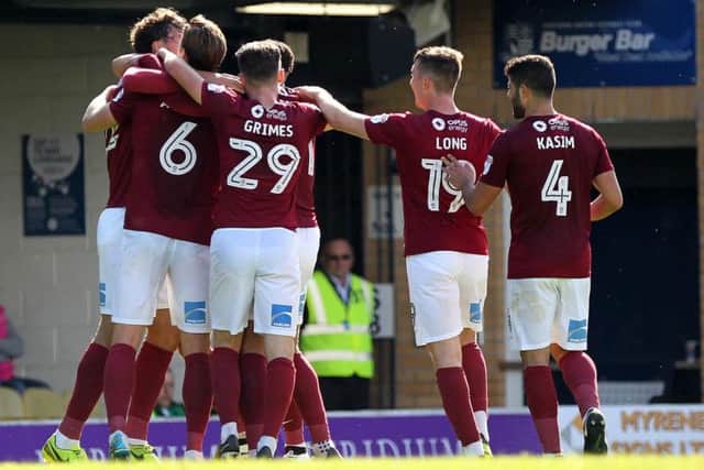 Matt Crooks is mobbed after firing the Cobblers into a 2-0 lead at Southend United (Pictures: Sharon Lucey)