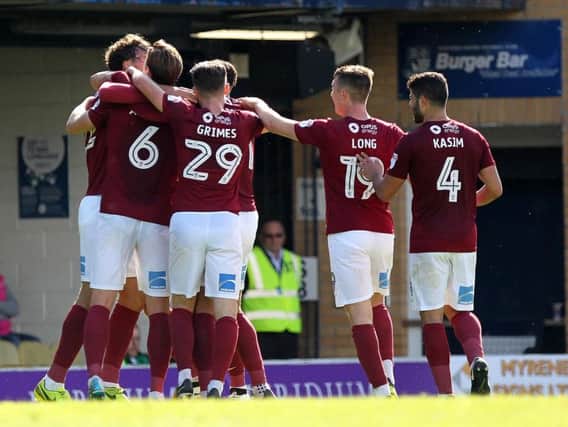 Matt Crooks is mobbed after firing the Cobblers into a 2-0 lead at Southend United (Pictures: Sharon Lucey)