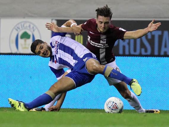 Matt Grimes battles for the vall during the Cobblers' defeat at Wigan Athletic (Pictures: Sharon Lucey)