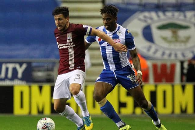 Dave Buchanan holds off the attentions of former Cobblers striker Ivan Toney