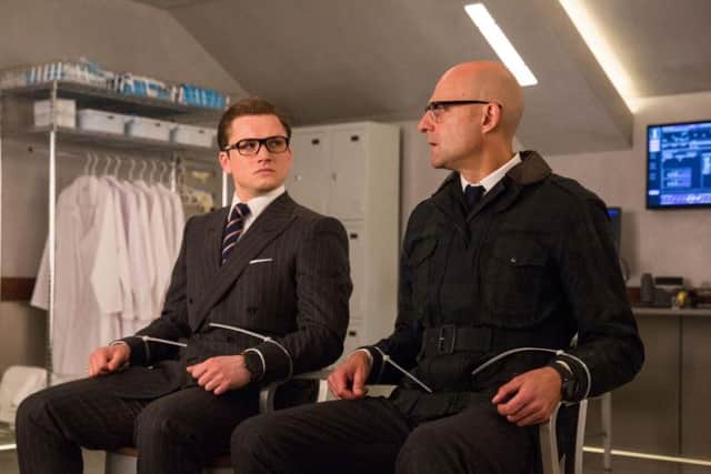 Taron Egerton as Eggsy and Mark Strong as Merlin