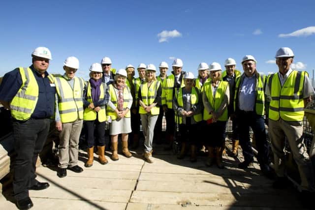 Former employees, site members and Oakdale Care Group staff toured the building site before bedding the last roof tile at Timken Grange.