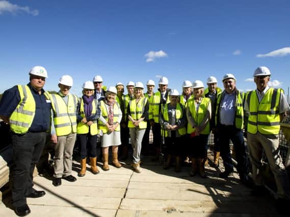 Former employees, site members and Oakdale Care Group staff toured the building site before bedding the last roof tile at Timken Grange.