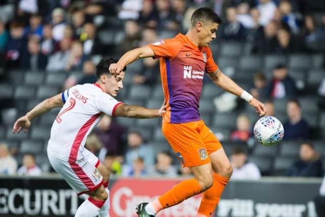 Alex Revell on the ball in the clash at MK Dons