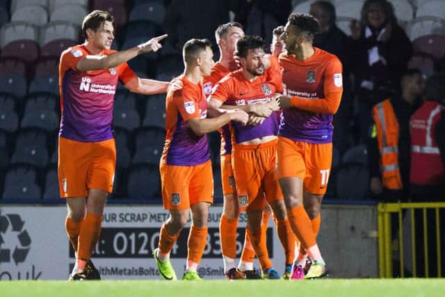 OFF THE MARK - Dave Buchanan is mobbed after his goal at Rochdale (Pictures Kirsty Edmonds)