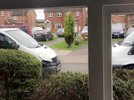 The view from on man's window after vans blocked his driveway today. "It's been going on like this for months."