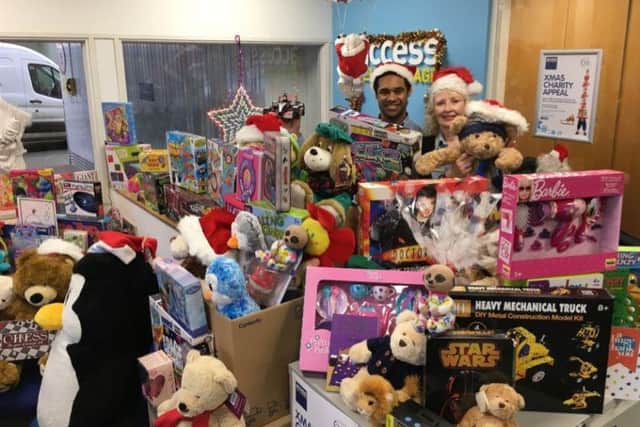 Some of the gifts collected in last years Access Self Storage Christmas Charity Appeal, with team membersJulian Hamilton Advisor and Deslynn Barter.