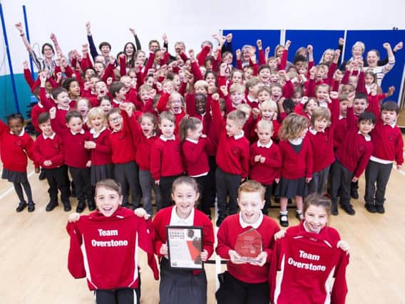 The school shows off its award (and new tracksuits).