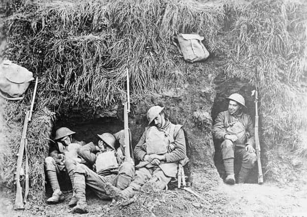 Troops of the 1st Battalion, Northamptonshire Regiment resting in a front-line trench at Molain, October 17, 1918