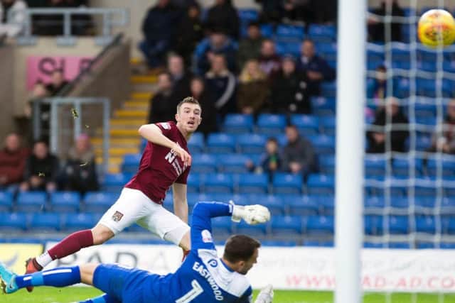 BACK IN FRONT: Chris Long beats Simon Eastwood to restore Northampton's lead over Oxford United. Pictures by Kirsty Edmonds
