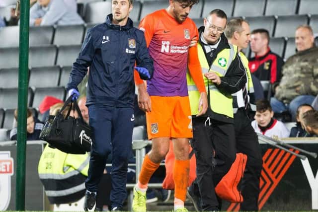 Matt Crooks trudges off the Stadium MK pitch after he suffered his knee injury in September